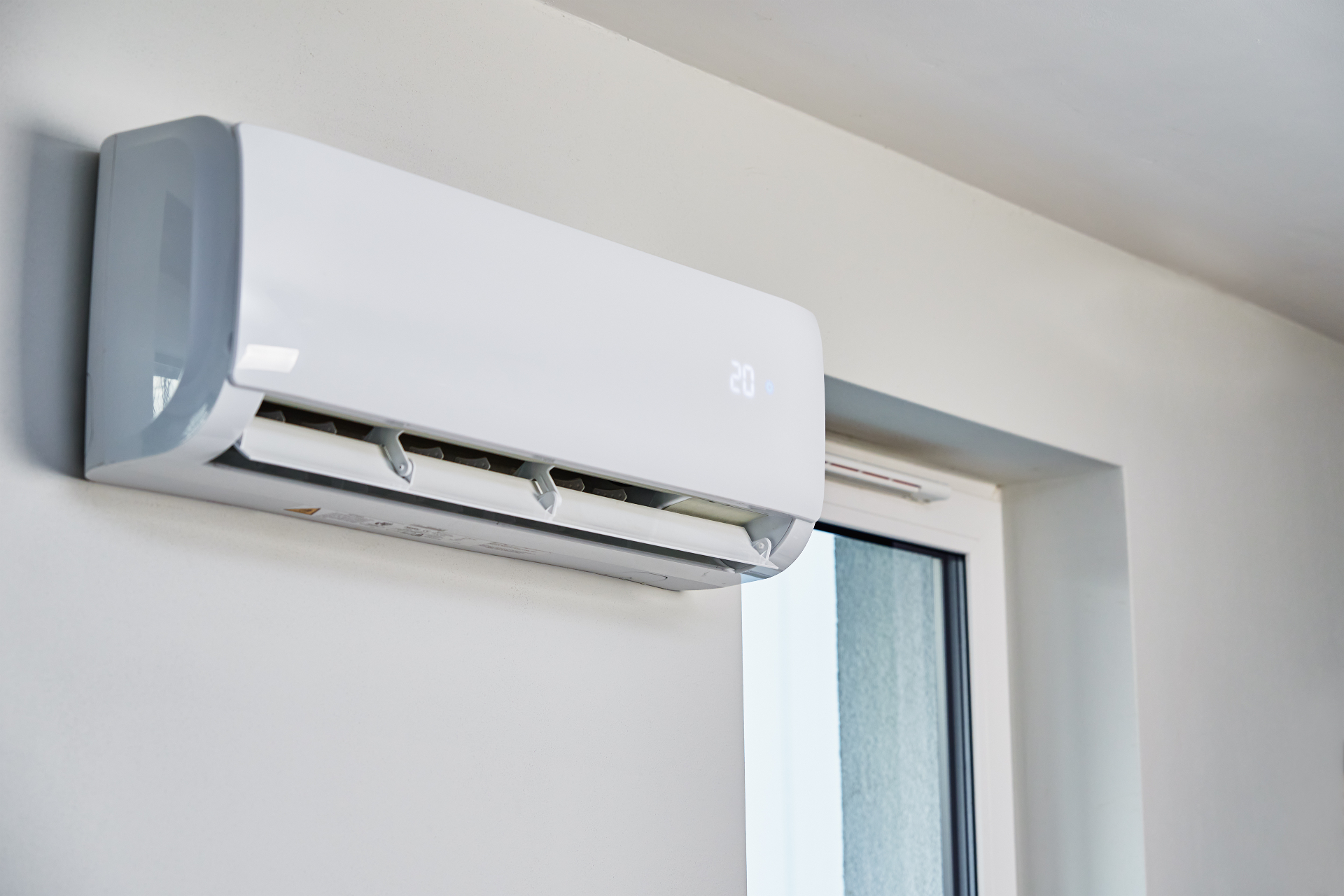 Wall-mounted air conditioning unit in a Bedfordshire bedroom installation.