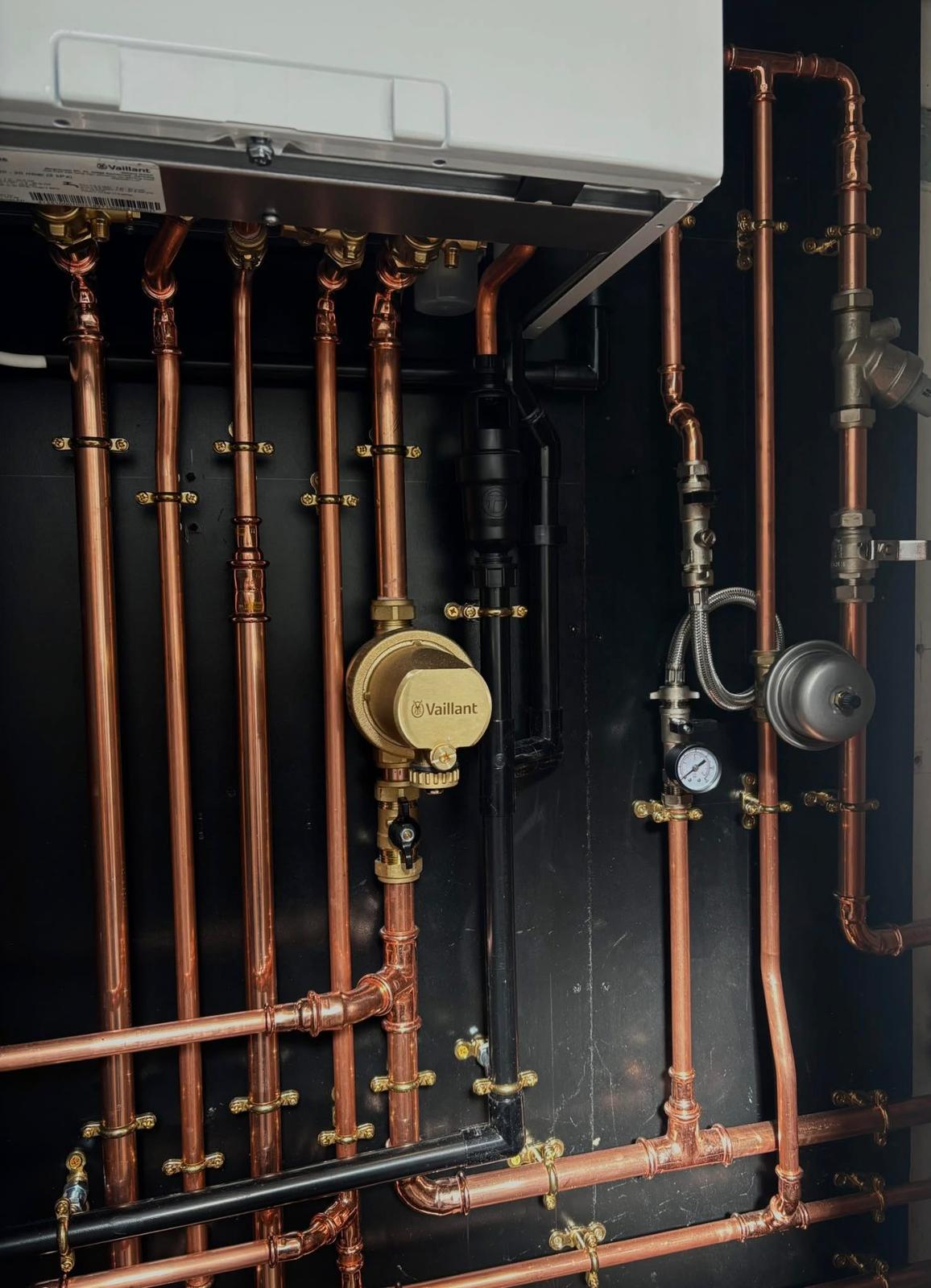 Wall-mounted combi boiler installation in a Bedfordshire kitchen.