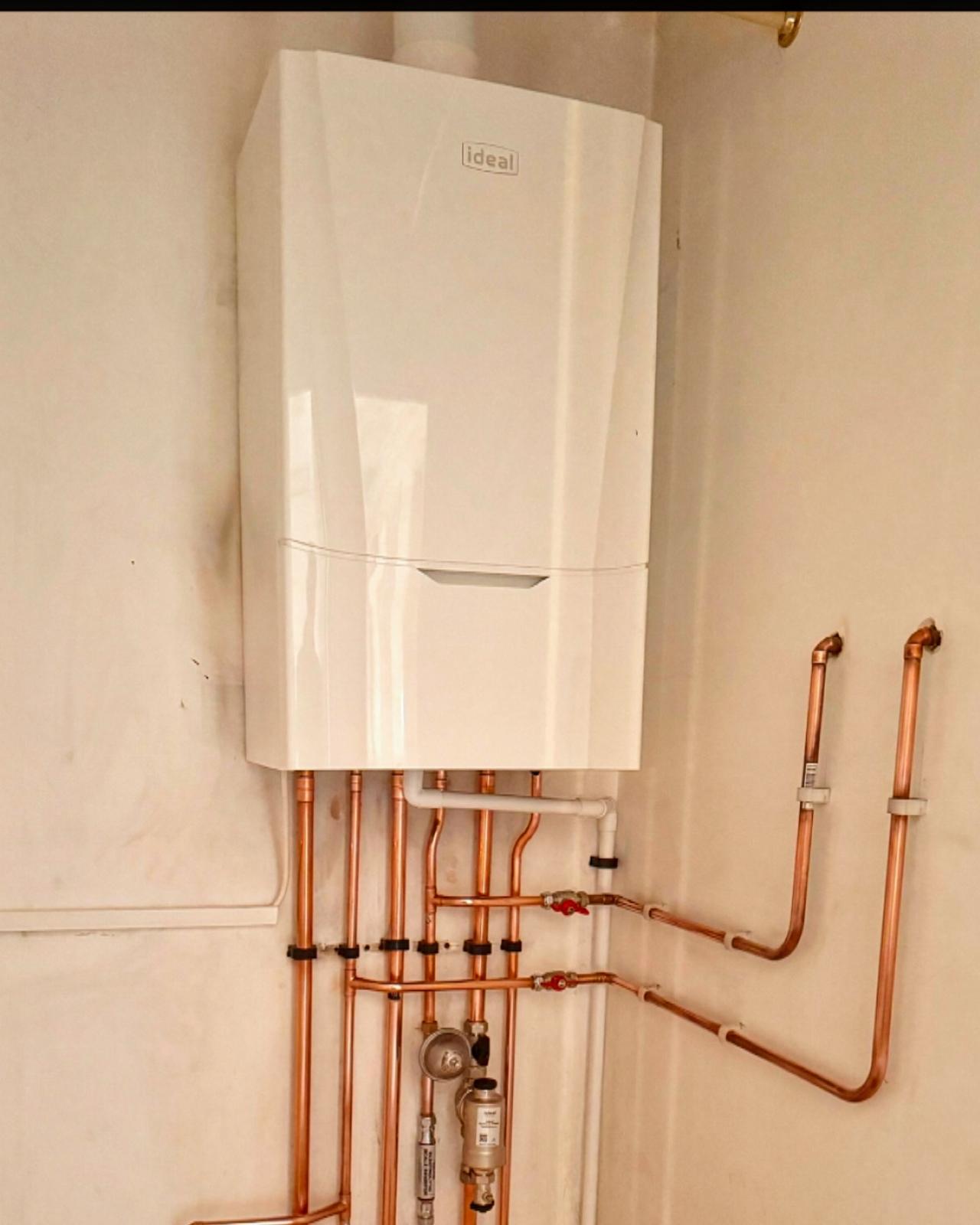 Ideal boiler installation with new pipework in a utility corner.