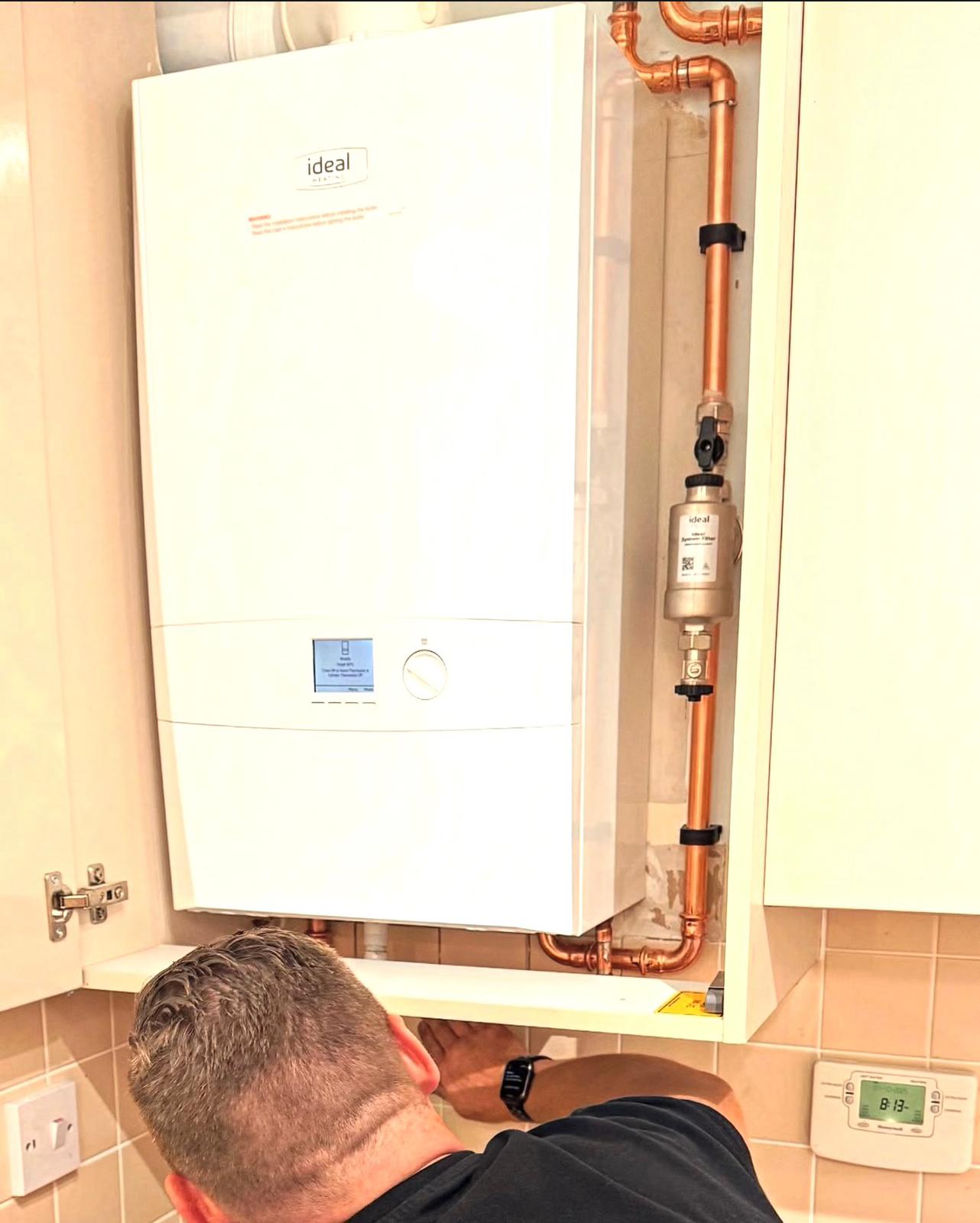 Ideal boiler installation inside a kitchen cupboard.